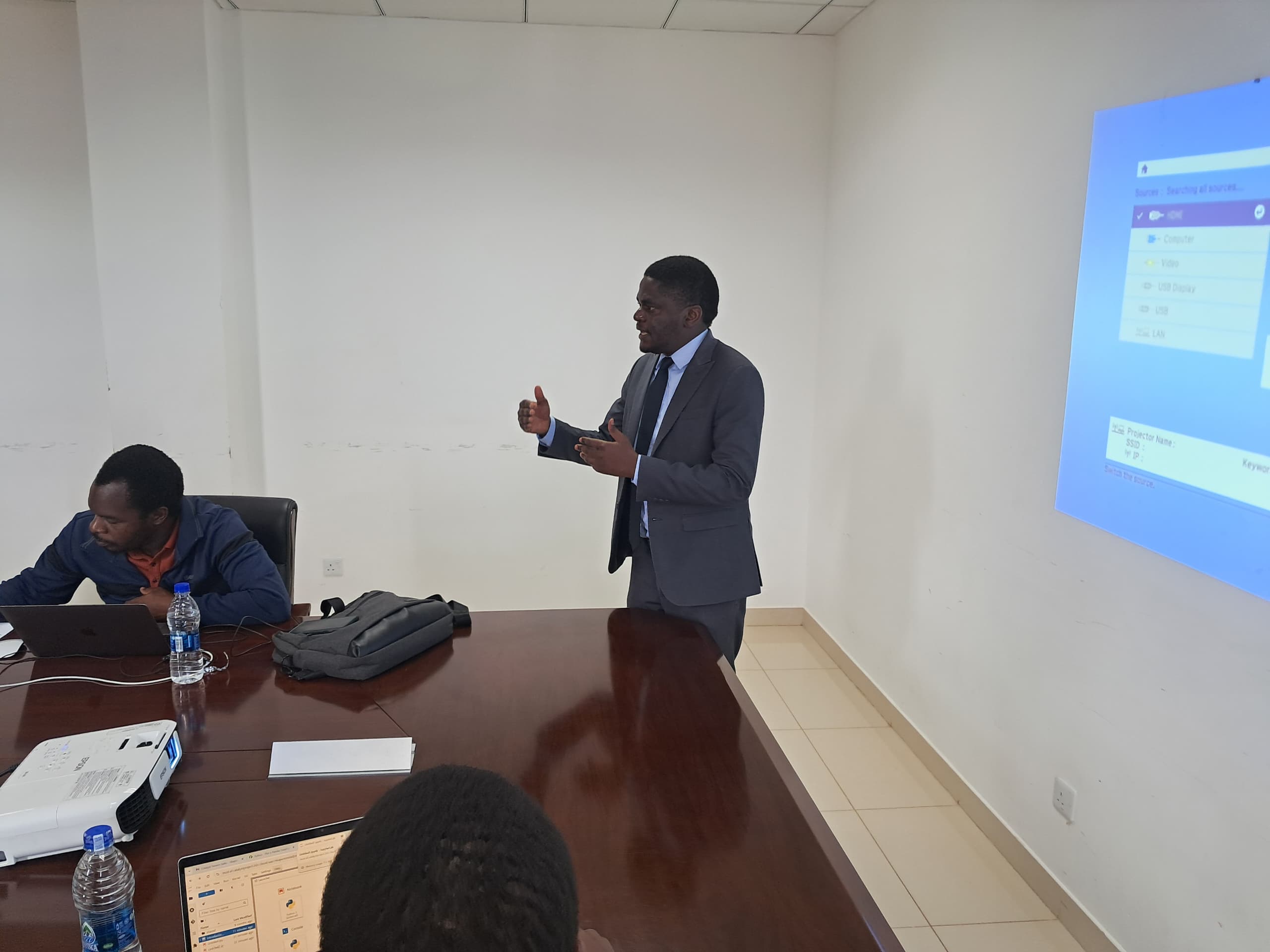 A photo of Dr. Bennett Kankuzi delivering a presentation.