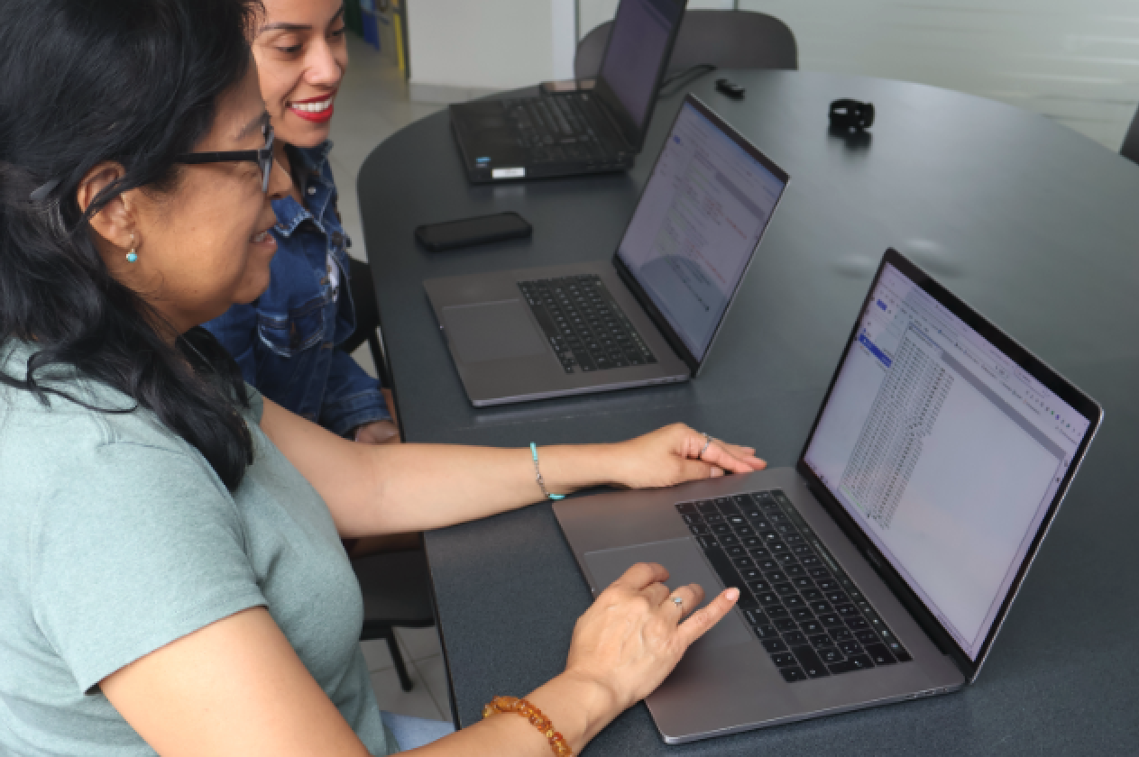 Shirley and Irma using the Catalyst hub on their laptops.